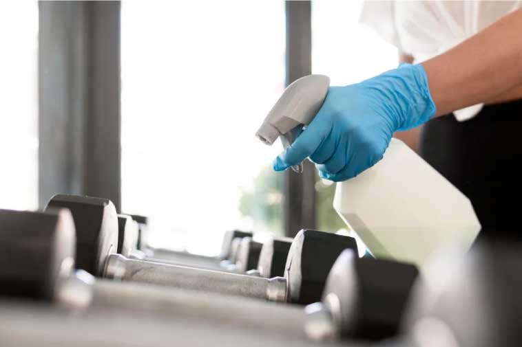 Close-up of a person performing a gym cleaning service