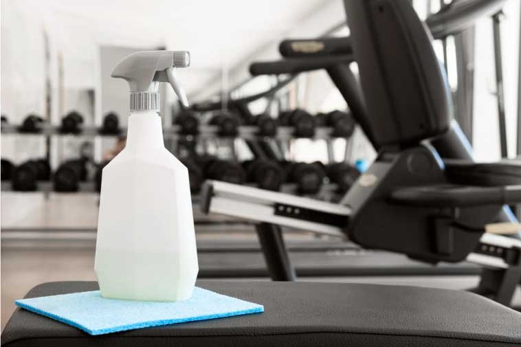 Spray and cleaning fiber on a bench in a gym