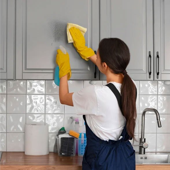 Woman in blue overalls providing top-notch cleaning services