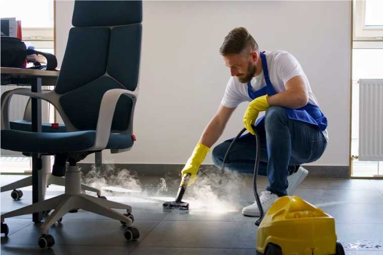 Man cleaning an office floor.