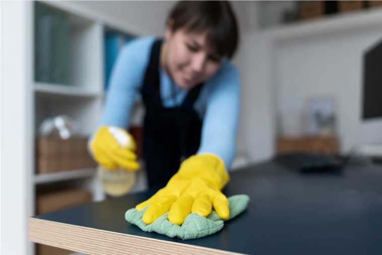 Tabletop view of a woman cleaning